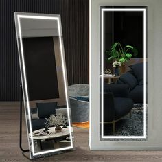 a large mirror sitting on top of a wooden floor