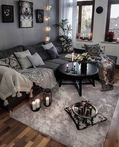 a living room filled with lots of furniture and candles on top of a coffee table