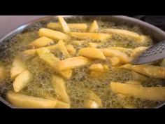 french fries being cooked in a frying pan