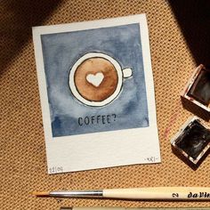 a coffee cup with a heart drawn on it next to some watercolor paints and a brush