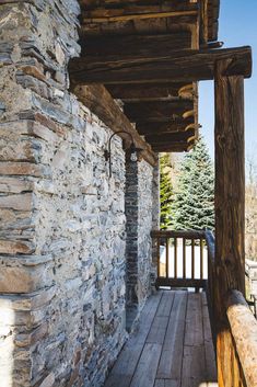 the porch is made out of wood and stone