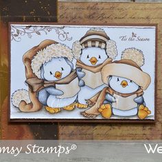 a card with three penguins wearing hats and scarves, one holding a snowman's hat