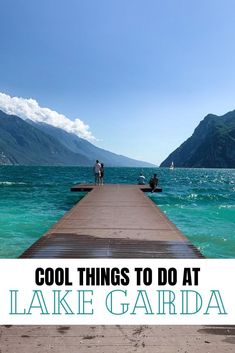 two people standing on a dock over the water with mountains in the background and text that reads cool things to do at lake garda