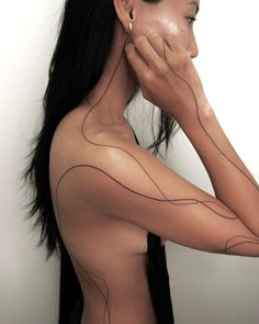 a woman with lines on her body and arm