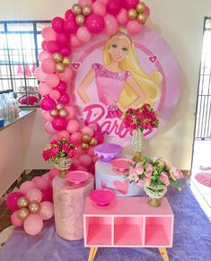 a barbie birthday party with balloons and decorations