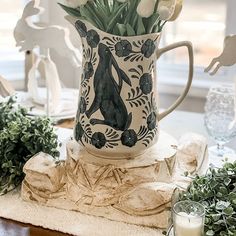 a vase filled with white flowers sitting on top of a table