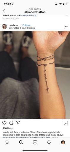 a person with a cross tattoo on their wrist