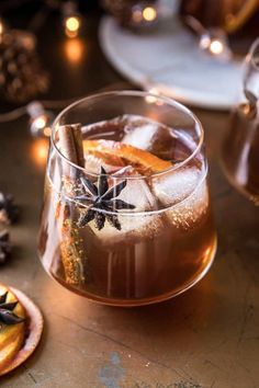 a glass filled with ice and cinnamon on top of a table