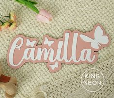 a wooden sign that says cantilla on it next to flowers and a teddy bear