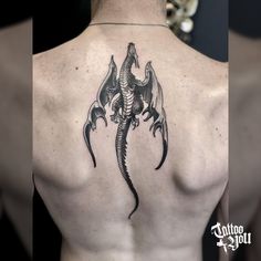 a man with a dragon tattoo on his back