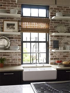 a white sink sitting under a window in a kitchen