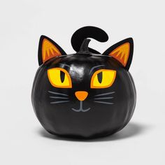 a black cat pumpkin with yellow eyes