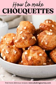 a white bowl filled with muffins on top of a table