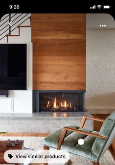 a living room with a fire place and a tv on the wall above it's fireplace