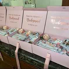 pink boxes filled with wedding items on top of a table