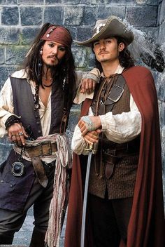 two men dressed in pirate costumes standing next to each other