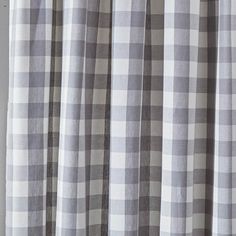 the curtain is pulled back and has a checkered pattern in grey, white and black