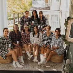 a group of women sitting next to each other on a porch