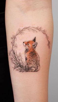 a small fox tattoo on the thigh