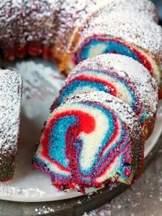 a cake that has been cut in half and is on a plate with powdered sugar