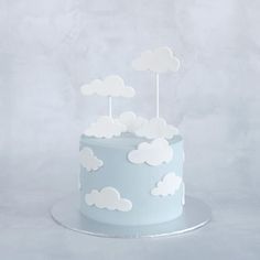 a blue cake with white clouds on it