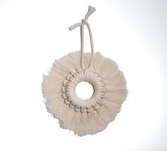 a round white object hanging from a rope