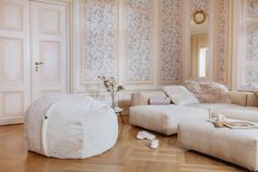 a living room filled with lots of white furniture