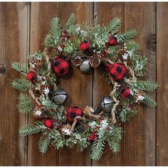 a christmas wreath hanging on a wooden wall