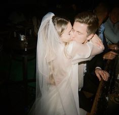 the bride and groom are kissing each other