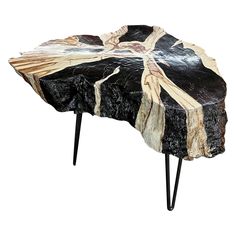 a wooden table with black legs and an artistic design on it's side end