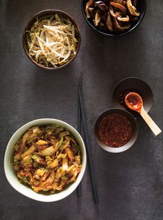 bowls of food and chopsticks on a table