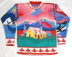 an ugly sweater that is on top of a white sheet with a house in the background