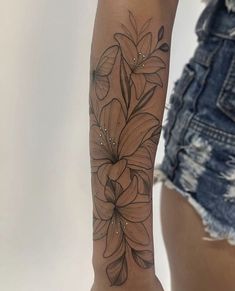 a woman with a flower tattoo on her arm