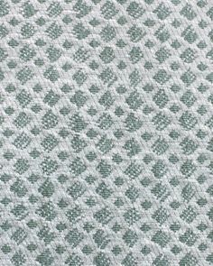 an up close shot of the texture of a fabric with diamond pattern in grey and white