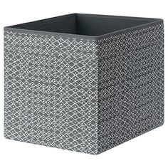 a gray and white square container with an intricate pattern on the front, sitting against a white background