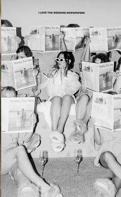 black and white photograph of people sitting on a couch with newspapers all over them, reading