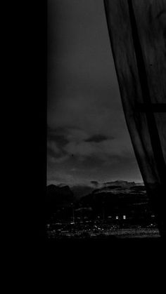 a black and white photo of the sky with mountains in the background