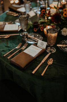 the table is set with silverware, napkins and place settings for an elegant dinner