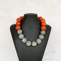 This chunky color block necklace was hand beaded using large 25mm round red orange and gray speckled ceramic beads - a fabulous look!  It measures approximately 20 inches in length and is secured with a silver toggle clasp.  This necklace adds a bold pop of earthy color to any outfit!  Length can be adjusted if needed - just ask! Check out my popular ceramic necklace collection here: https://www.etsy.com/shop/jewelbytessyla?ref=seller-platform-mcnav&search_query=ceramic+necklace Check out more f Izrada Nakita, Big Bead Necklace, Nana Jewelry, Gray Beaded Necklace, Earthy Necklace, Large Bead Necklace, African Accessories, Polymer Clay Jewelry Tutorials, Chunky Bead Necklaces