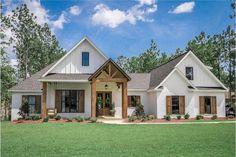 a white house with brown shutters in the front yard