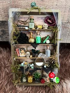 a shelf filled with assorted items on top of a furry floor next to a wooden wall