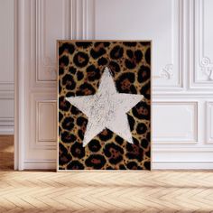 a white star on a leopard print background in a room with wood flooring and walls