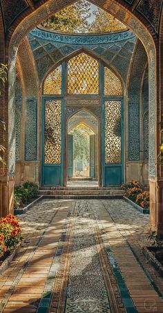 the entrance to an ornate building with blue and green doors, surrounded by plants and flowers