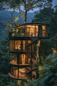 a spiral staircase leading up to the top of a tree house in the forest at night