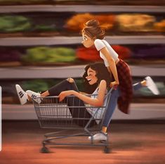 two people sitting in a shopping cart and one person standing on top of the other