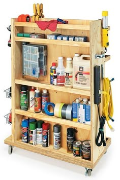 a wooden shelf filled with lots of different types of paint and other things on it