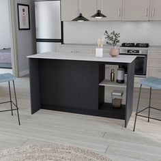 a kitchen with an island and stools in it