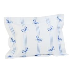 a blue and white pillow with bows on it