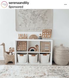 a white shelf filled with baskets and toys