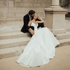 a bride and groom are sitting on the steps